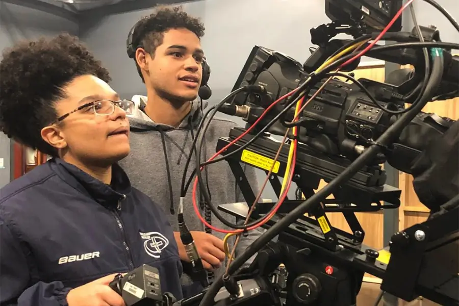 two teens working a video camera